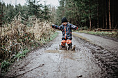 Toddler playing on muddy path in the forest, child, playing, forest