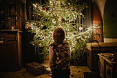 little boy stands in front of the Christmas tree, Christmas, family