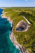 France, Caribbean, Lesser Antilles, Guadeloupe, Guadeloupe, Marie-Galante, Saint-Louis, aerial view of the Gueule Grand Gouffre (50 m high), a natural arch dug by the sea