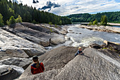 Family at the salmon river Sandola, tributary of the Namsen, Namdalen, Norway