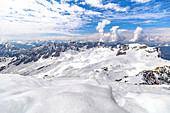 View from Zugspitze summit on glacier and mountain landscape in the snow, Grainau, Upper Bavaria, Germany