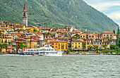 Speedboat in front of Varenna on Lake Como seen from the lake side, Lombardy, Italy