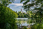 View in sunshine over the Höglwörther See to the monastery, Chiemgau, Bavaria, Germany