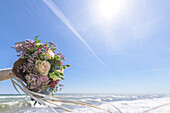Wedding bouquet with waving ribbons over the sea, wedding, Baltic Sea, roses, waves