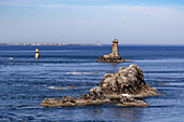 France, Bretagne, Finistere sud, Rocks in sea and lighthouse
