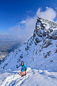 Woman on ski tour climbs on foot to Hohen Kisten, Hohe Kisten, Estergebirge, Bavarian Alps, Upper Bavaria, Bavaria, Germany