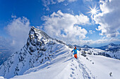 Woman on ski tour climbs on foot to Hohen Kisten, Hohe Kisten, Estergebirge, Bavarian Alps, Upper Bavaria, Bavaria, Germany