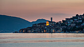 Village of Peschiera Maraglio on the island of Monte Isola on Lake Iseo with village church at sunset, Italy