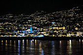 View from the harbor on the nightly Funchal with the cathedral, Madeira, Portugal, Europe