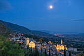 View of Assisi at dusk with the Cathedral of San Rufino and the Basilica di Santa Chiara, Province of Perugia, Umbria, Italy