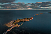 Coast and lighthouse Lange Erik in the north of the island of Öland in the east of Sweden from above in the sun