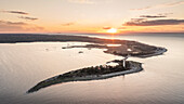 Coast and lighthouse Lange Erik in the north of the island of Öland in the east of Sweden from above at sunset