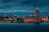 Illuminated Stockholm skyline at night with Stadshus in Sweden