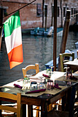 Gedeckter Tisch von einem Restaurant mit der italienischen Fahne in Cannaregio, Venedig, Venezien, Italien, Europa\n