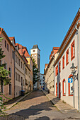 Nikolaigasse in the old town of Freiberg, with the Nikolaikirche in the background, Saxony, Germany