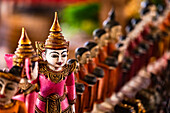 A brightly painted wooden figure on a market stall in the Shan State of Myanmar, Asia