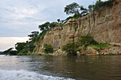 Uganda; Northern Region on the border with the Western Region; Murchison Falls National Park; Riverside landscape on the Victoria Nile; green vegetation and steep cliffs