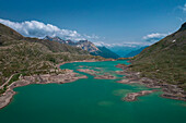 Landscape at the Lago Bianco reservoir at the Bernina Pass in the sun from above