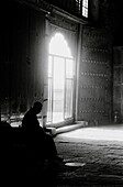 Silhouette of a Buddhist monk inside a dark temple, Datong, China