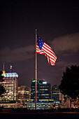 The Star Spangled Banner Flag flies over the Baltimore skyline at Federal hill Park.