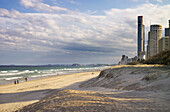 View along beach and down the coastline with Surfers Paradise high rise resorts emerging out of the sand