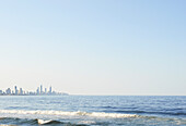 View across calm water at Surfers Paradise city on sunny day