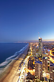 Aerial of coastline of Surfers Paradise showing beach and city skyline in the early evening