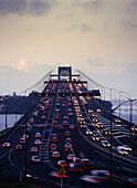 Traffic flowing both ways on Auckland Harbour Bridge at dusk
