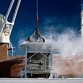 Unloading salt into hopper at the wharf from supply ship