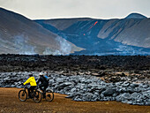 Mountainbiker, einheimische Isländer, die Lavaströme vom Vulkan Fagradalsfjall, Island, besuchen