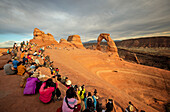 Moab, Delicate Arch at sunset with crowd