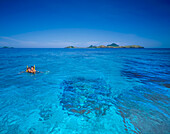 Couple snorkelling in tropical water in the Fiji Islands