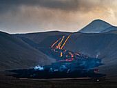 Glühende Lavakaskade, die steil bergab fließt, Vulkan Fagradalsfjall, Island