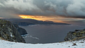Coastal landscape at Nordkapp, Finnmark, Norway, sunset. snow in the foreground.