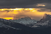 Mountain panorama at sunrise, South Tyrol, Chiusa, Italy. sunbeams, snow.