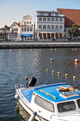 View of the shore at the Alter Strom in Warnemünde near the train station bridge in the morning.