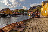 Wooden pier, old warehouse, fishing trawler in Nusfjord, Flakstad, Lofoten, Norway.
