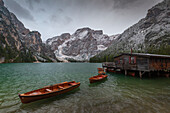 Wooden hut with rowing boats at the Pragser Wildsee, Braies, South Tyrol, Italy.