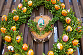 Painted Easter eggs, fountain house decorated with colorful Easter eggs with Easter crib in Birkenreuth in Franconian Switzerland, Bavaria, Germany