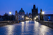 Charles Bridge with Old Town Bridge Tower, Church of the Cross, dawn, Prague, Czech Republic