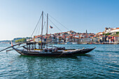 Barcos Rabelos, port wine boats on the Duero River in front of the historic old town of Porto, Portugal
