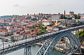 Dom Luís I truss arch bridge over Douro river and historic old town in Porto, Portugal