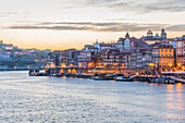 Night shot of the Cais de Ribeira waterfront promenade and the historic old town of Porto, Portugal