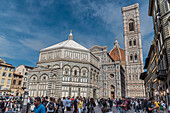 People in front of the baptistery and facade of the Duomo, Cathedral of Santa Maria del Fiore, Florence, Tuscany, Italy