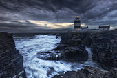 LHooks Head lighthouse on cliffs in stormy seas. After sunset. Churchtown, County Wexford, Ireland.tif