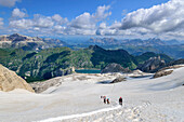 Several people ascend over snow-capped glacier to the summit of Marmolada, Marmolada, Dolomites, Dolomites UNESCO World Heritage Site, Trentino, Italy