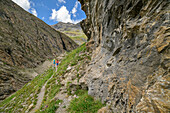 Man and woman hiking up the Lenta to the Col d'Iseran, Vanoise National Park, Vanoise, Savoie, France