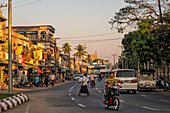 Traffic in a town, cars and motorbikes, and people, Myanmar, Asia