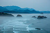 Indian Beach on Ecola State Parl with mist over waves breaking at dawn.