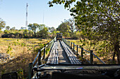 Safari-Fahrzeug überqueren Fourth Bridge, Okavango Delta, Botswana.